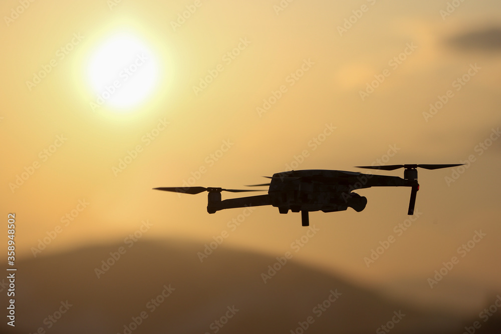 The drone in the sunset sky. The drone in the sunset sky.