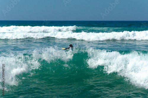 Surfer rides on a wave in the Atlantic ocean. Blue sky, banner. High quality photo
