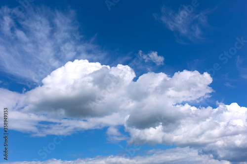 White clouds on blue sky background.