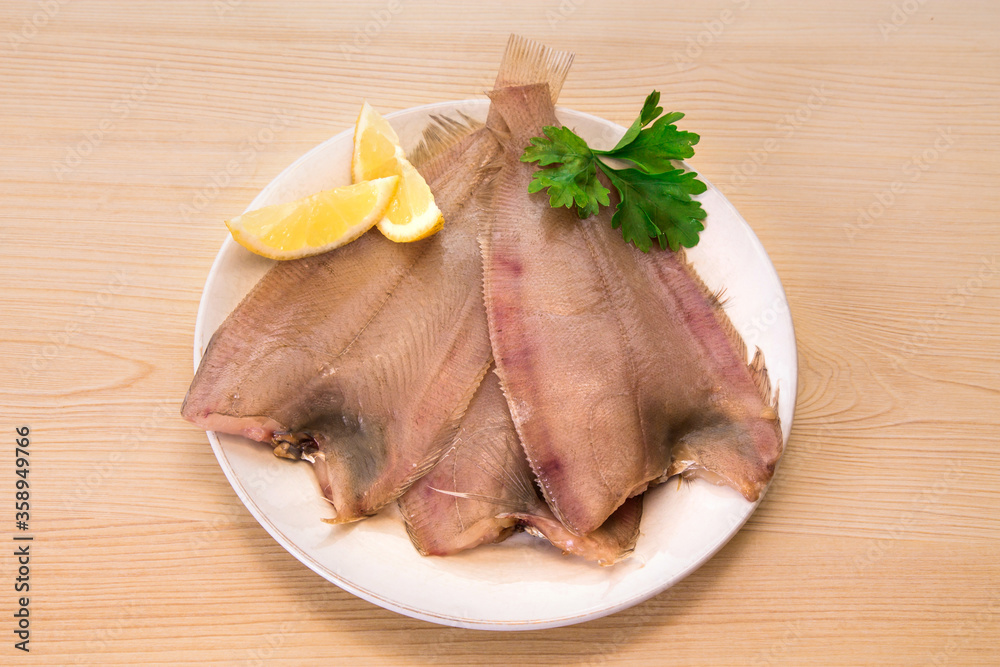 fresh fish, roosters with parsley and lemon