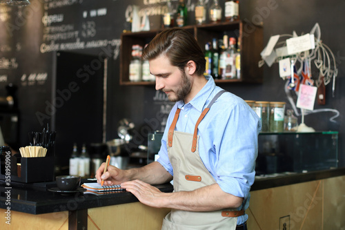 Small business owner working at his cafe.