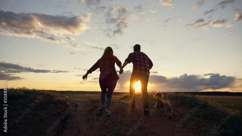 Teamwork. A happy family at sunset on the way to success. Healthy lifestyle, travel. Concept of freedom. Teamwork. A happy family at sunset on the way to success. Healthy lifestyle, travel. Concept of freedom.