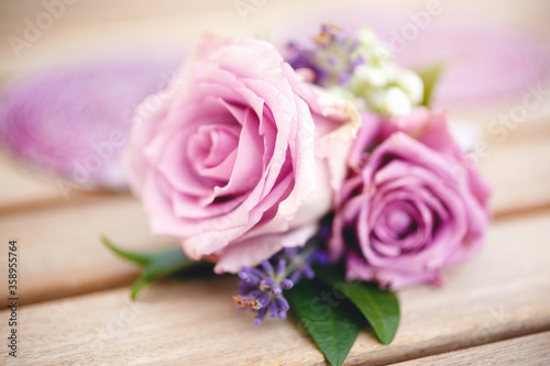 Boutonniere for groom made of purple roses