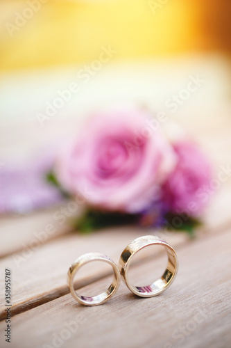 Two beautiful wedding rings on wooden backgrond