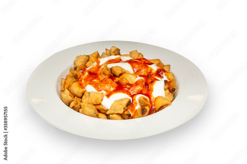 Ravioli - Turkish Manti on plate with red pepper. Isolated