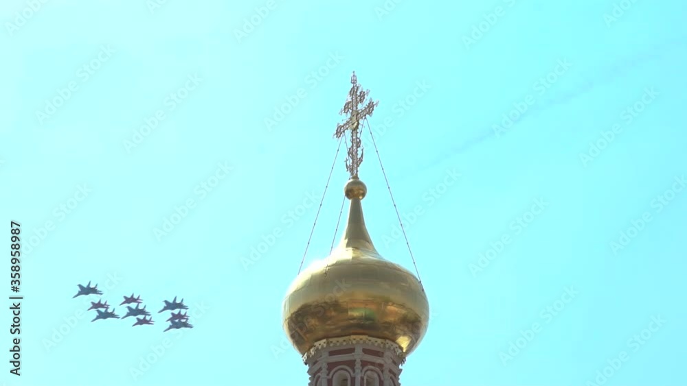 Military aircraft fly over the dome of the temple with a cross close-up, Russian aviation training before the glories of the Great Patriotic War 1945. Moscow Military aircraft fly over the dome of the temple with a cross close-up, Russian aviation training before the glories of the Great Patriotic War 1945. Moscow