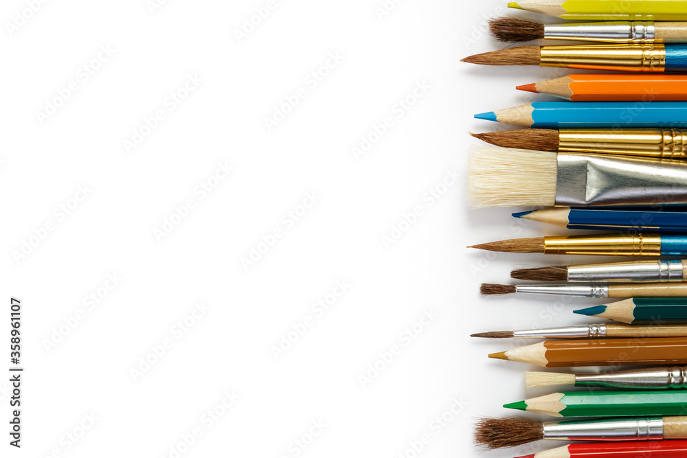 brushes and color pencils on a white background brushes and color pencils on a white background