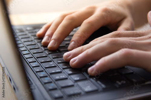 female hands typing on a keyboard