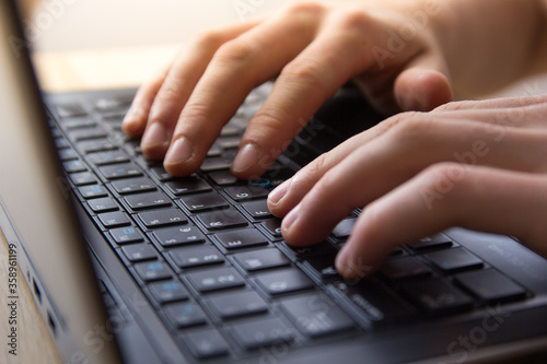 hands typing on a keyboard