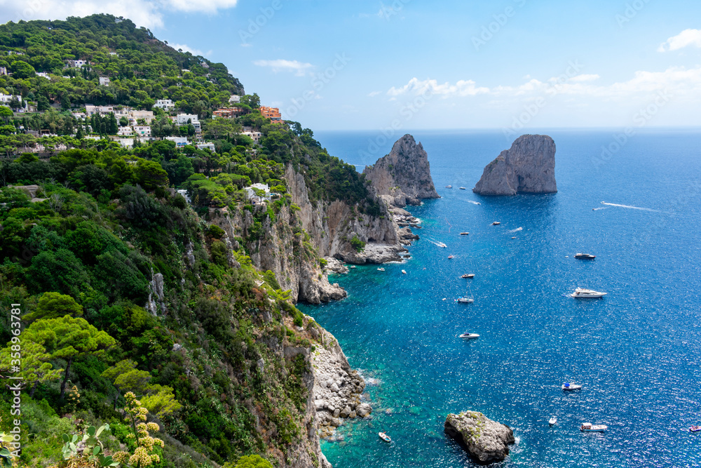 Italy, Campania, Capri - 14 August 2019 - Picturesque view of the Faraglioni of Capri from the Gardens of Augustus