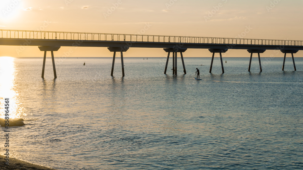 Fototapeta premium young boy doing paddle surf in the sea