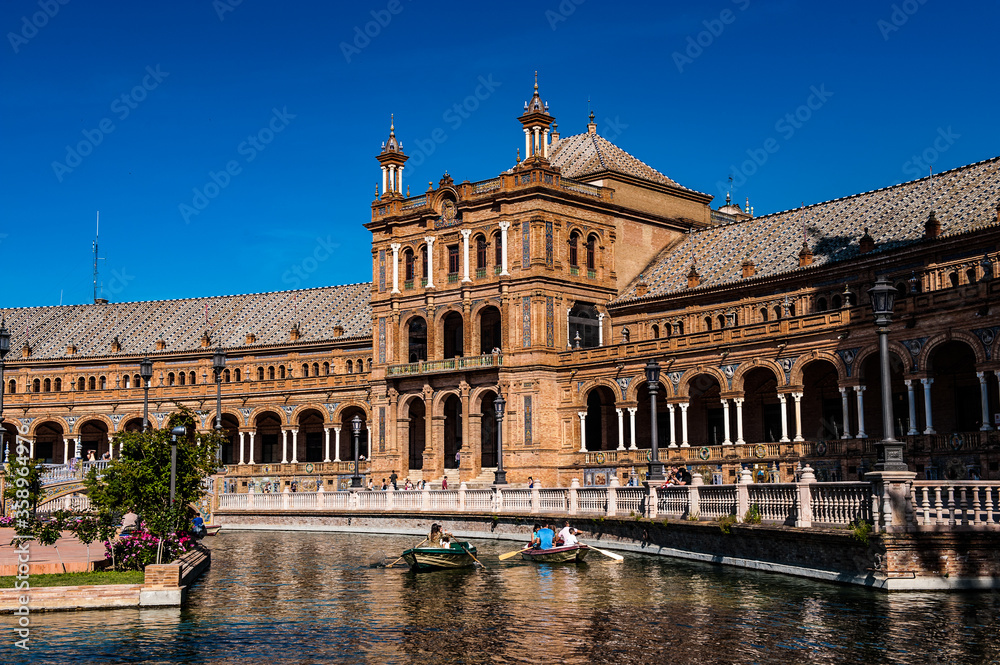 It's River with boats near Central building at the Plaza de Espana in Seville, Andalusia, Spain. It's example of the Renaissance Revival style in Spanish architecture.