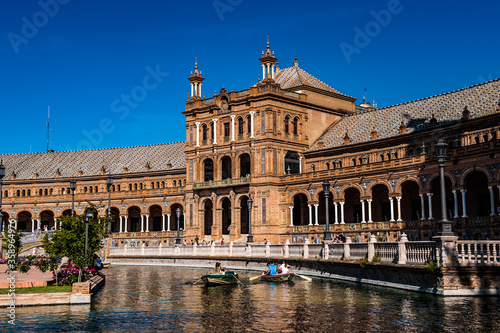 It's River with boats near Central building at the Plaza de Espana in Seville, Andalusia, Spain. It's example of the Renaissance Revival style in Spanish architecture.