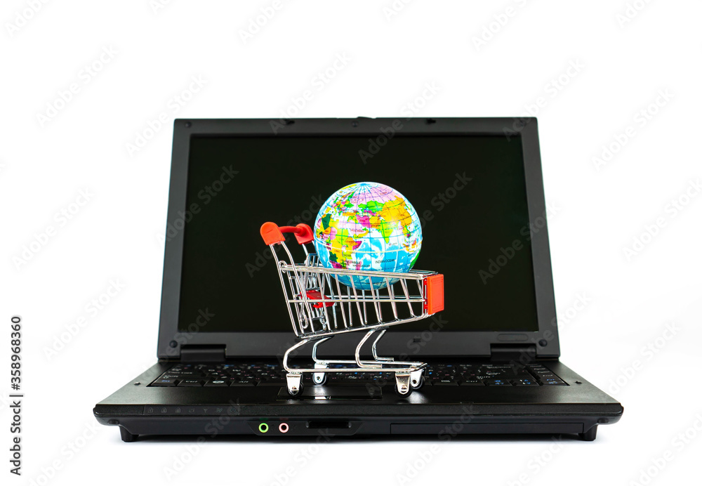 Globe figure in the shop trolley standing on the laptop. Globe figure in the shop trolley standing on the laptop.