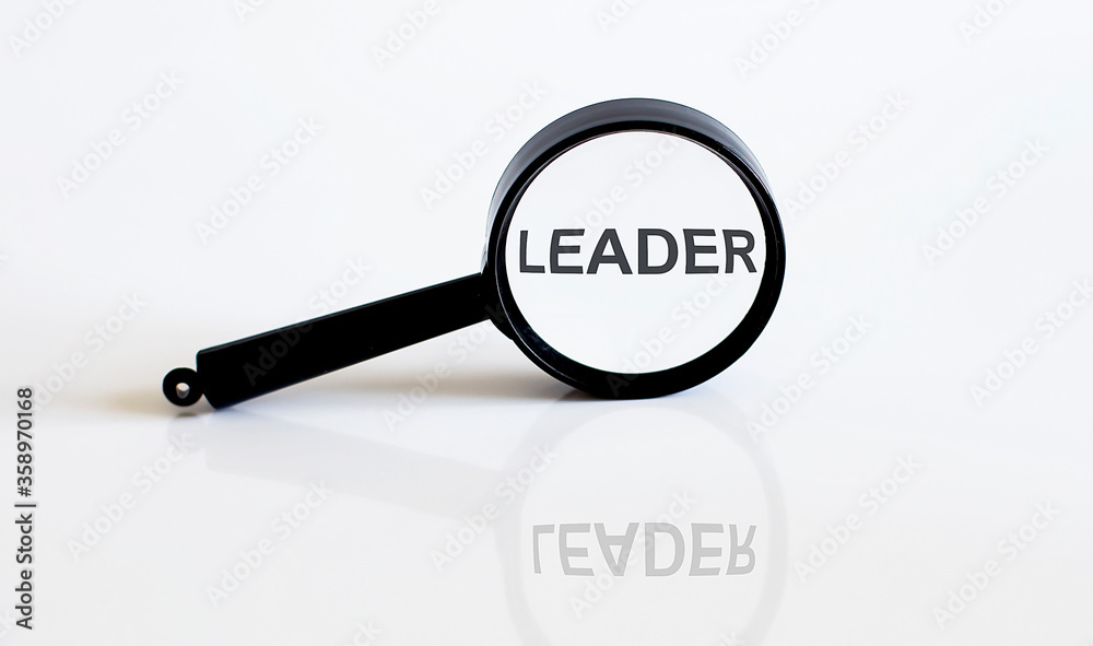 Magnifier with text LEADER on the white background Magnifier with text LEADER on the white background
