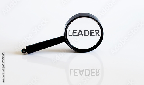 Magnifier with text LEADER on the white background
