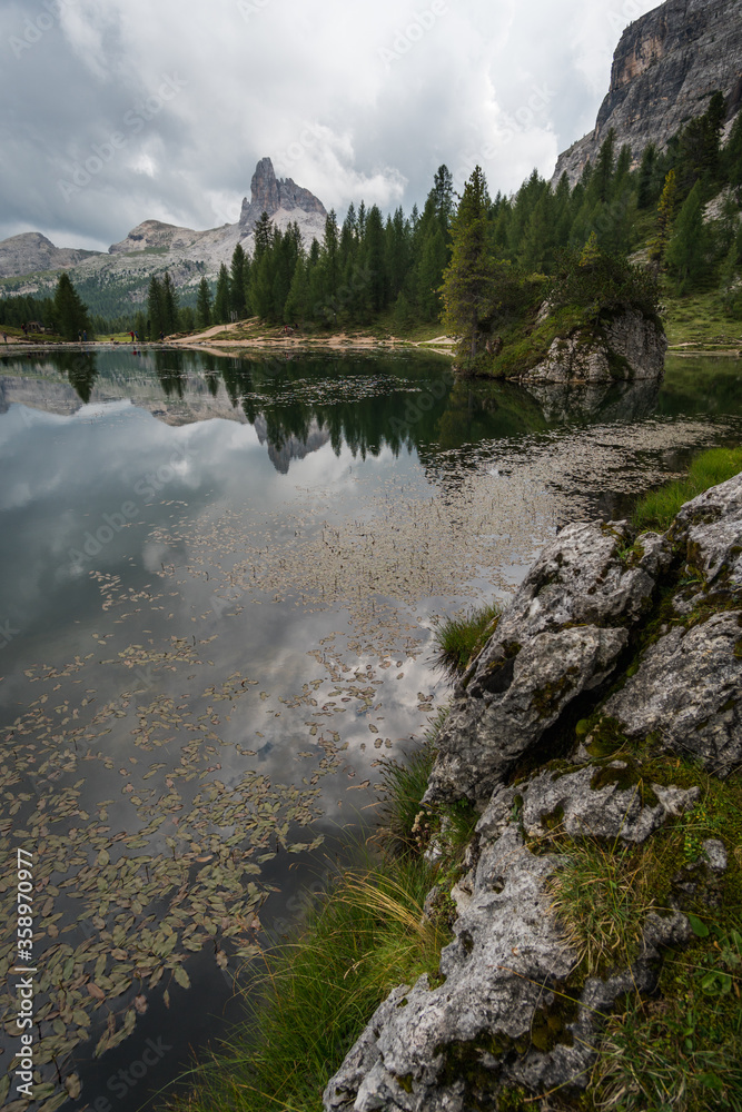 Lake reflection of tourist shelter (Rifugio Croda da Lago) and soaring mountain in Dolomites, Italy Lake reflection of tourist shelter (Rifugio Croda da Lago) and soaring mountain in Dolomites, Italy