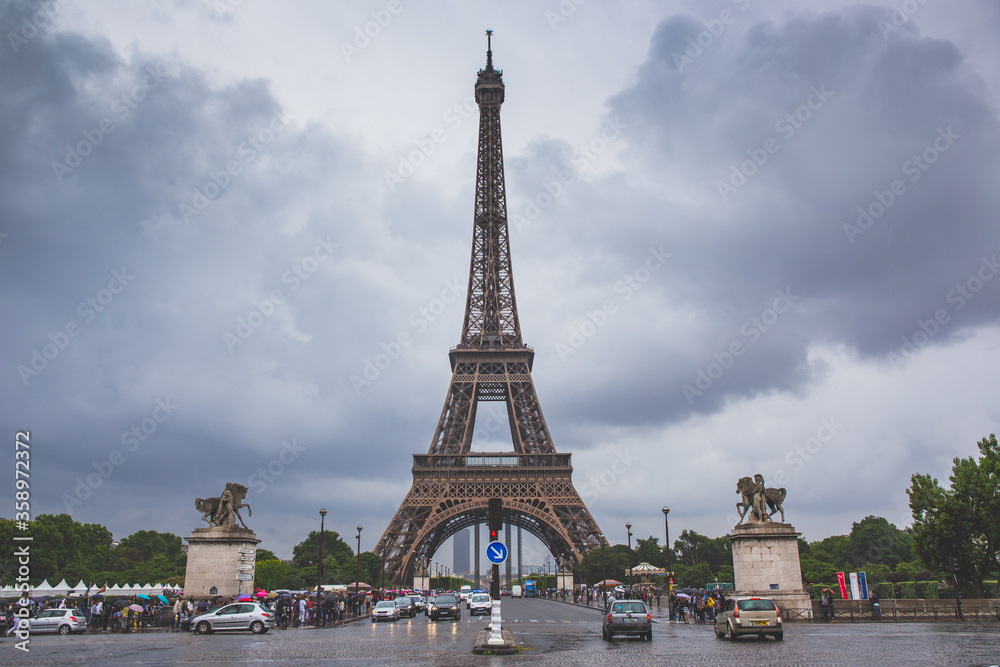 The eiffel tower on a cloudy day, in Paris, France.