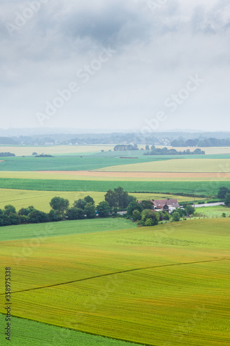 Rural landscape with green field in a cloudy day