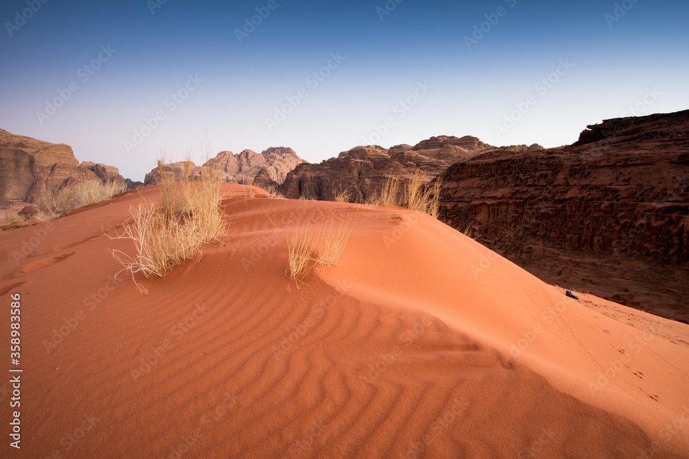 Red sand dunes on Wadi Rum desert in Jordan. Spectacular landscape of orange desert.