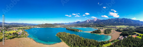 Faaker See in Carinthia. Aerial view to the beautiful lake and the Mittagskogel mountain in the south of Austria.