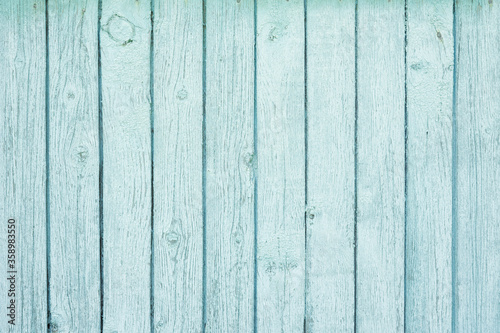 Wooden background covered with shabby old blue paint.
