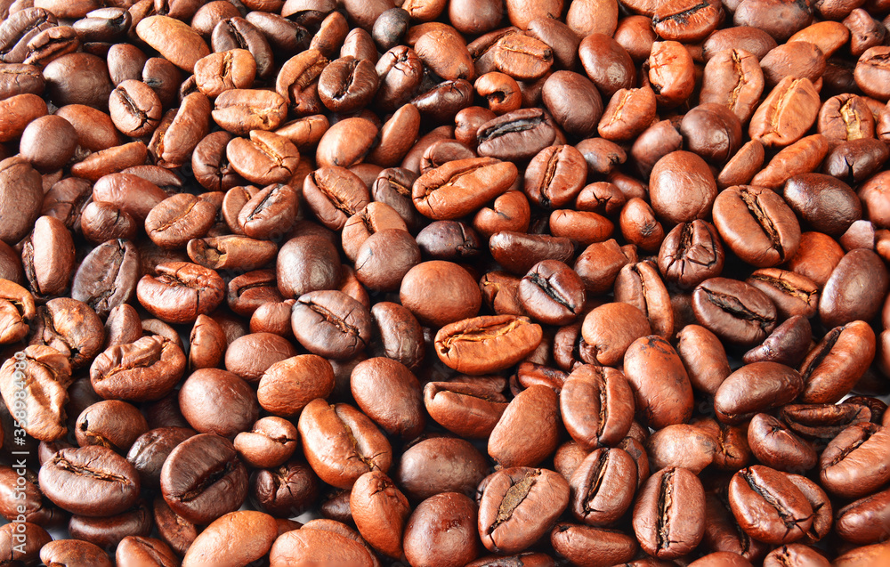 Fragrant, roasted coffee beans, top view, background from coffee beans Fragrant, roasted coffee beans, top view, background from coffee beans