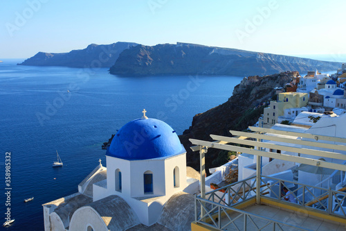 A blue domed church on the coast in Santorini, Greece.