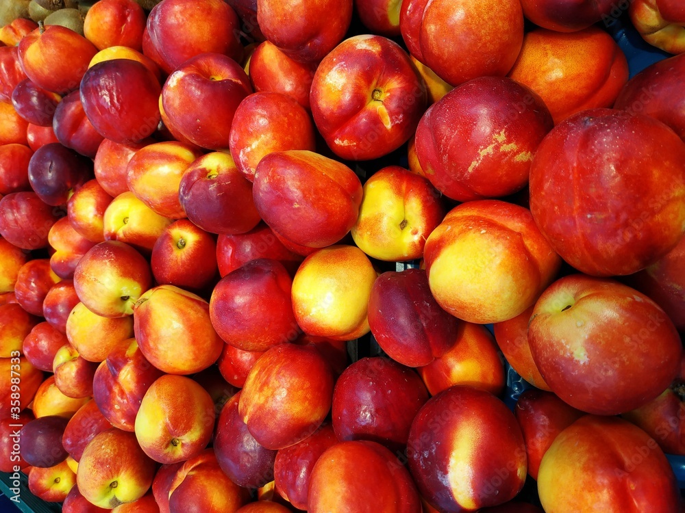 Juicy and ripe looking raw peaches , ready for sale in market. Close up shot. Juicy and ripe looking raw peaches , ready for sale in market. Close up shot.