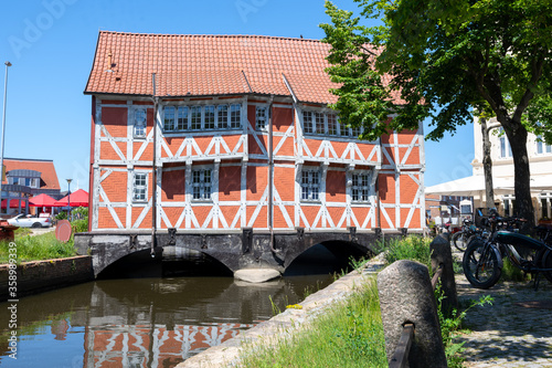 Red half-timbered house from the 17th century called Gewoelbe (vault), protected as a historic monument and famous landmark in the old town of Wismar, Germany photo