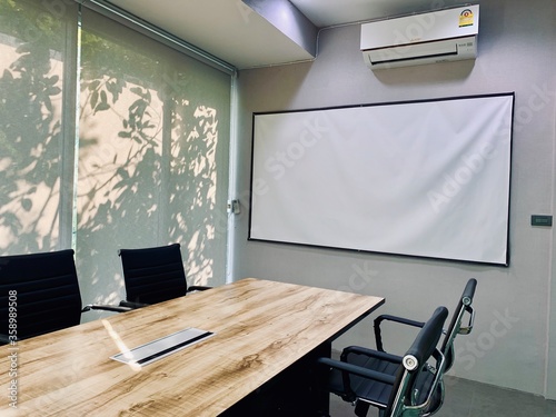 An empty business meeting room with presentation screen board in modern office. Interior of meeting room. Home office, Classroom and Co-working space.