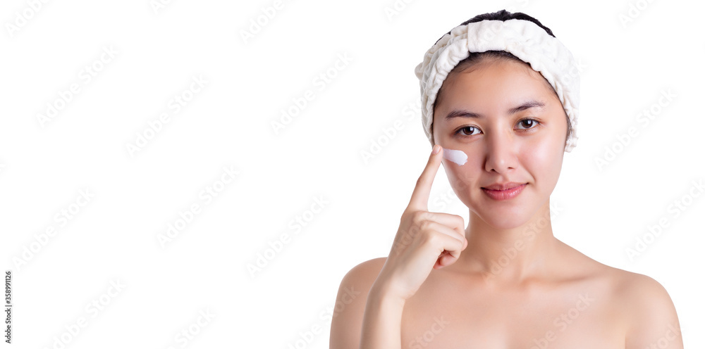 Beautiful asian woman apply face cream, lotion to beautiful skin on face. Young female apply moisturizer on facial skin. Pretty girl has beauty facial skin. isolated on white background copy space Beautiful asian woman apply face cream, lotion to beautiful skin on face. Young female apply moisturizer on facial skin. Pretty girl has beauty facial skin. isolated on white background copy space