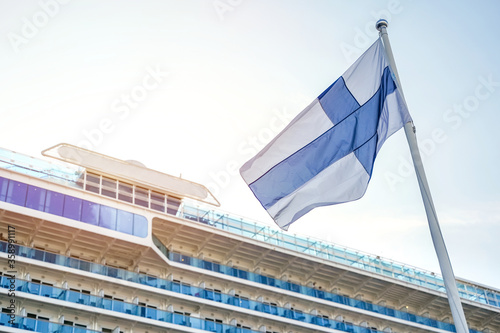 Multistorey cabins of a passenger cruise sea liner in port of Helsinlki with finnish flag waving