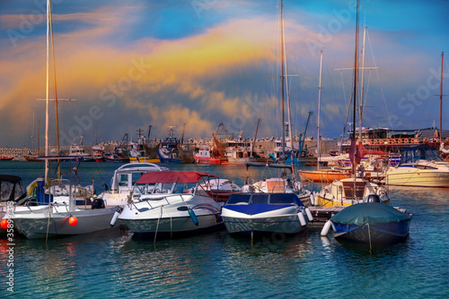 Old port of Constanta with sailing boats and ships on the Black Sea illuminated by sunset
