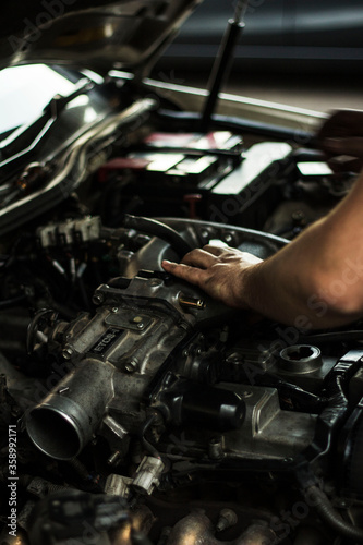  Auto mechanic working on spare parts for a car