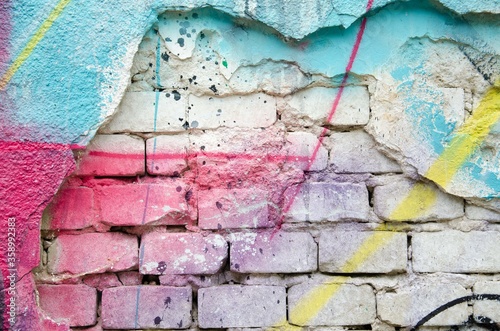 Old stone wall, street mural, fragment of graffiti modern art background.