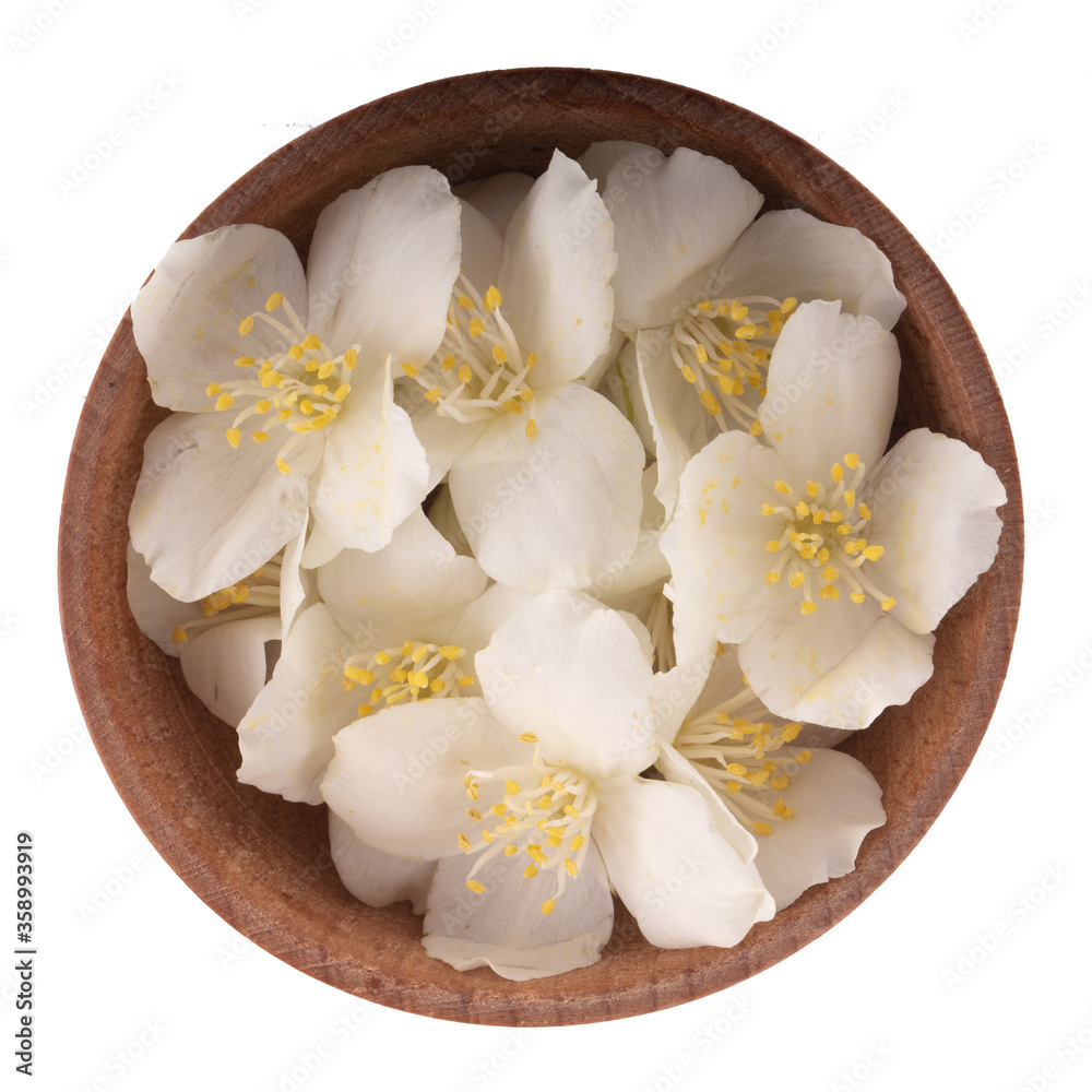 heap of white jasmine flowers in wooden cup isolated on white background. top view heap of white jasmine flowers in wooden cup isolated on white background. top view