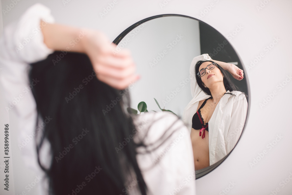 Sexy young woman in lingerie, glasses and white shirt posing while looking  in mirror. Beautiful woman in morning. Boudoir, Caucasian model admiring  herself mirroring herself in beautiful bathroom Photos | Adobe Stock