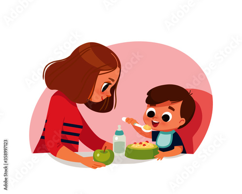 Mom feeding baby boy. Healthy food. Mother and little son. Raising of child.