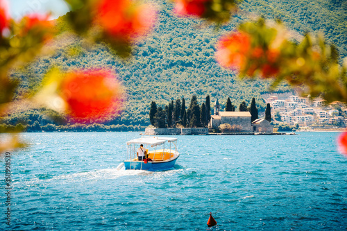 Obraz na płótnie Sightseeing boat with famous Sveti Dorde islet at the Bay of Kotor in summer, Perast, Montenegro w salonie