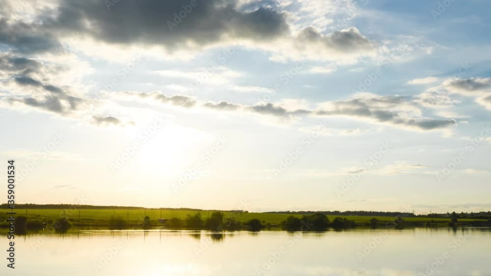 Timelapse of the sunset over the lake in fine summer weather