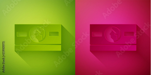 Paper cut Stacks paper money cash icon isolated on green and pink background. Money banknotes stacks. Bill currency. Paper art style. Vector Illustration.