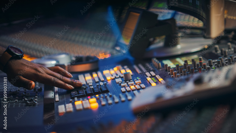 Close-up Shot of a Surface Control Desk Equalizer Mixer. Buttons, Faders, Sliders to Broadcast, Record, Play Hit Song. Artist Works in the Music Record Studio.