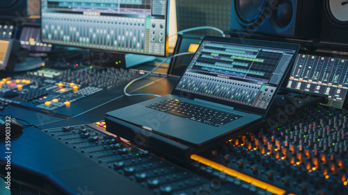 Slika na platnu Modern Music Record Studio Control Desk with Laptop Screen Showing User Interface of Digital Audio Workstation Software