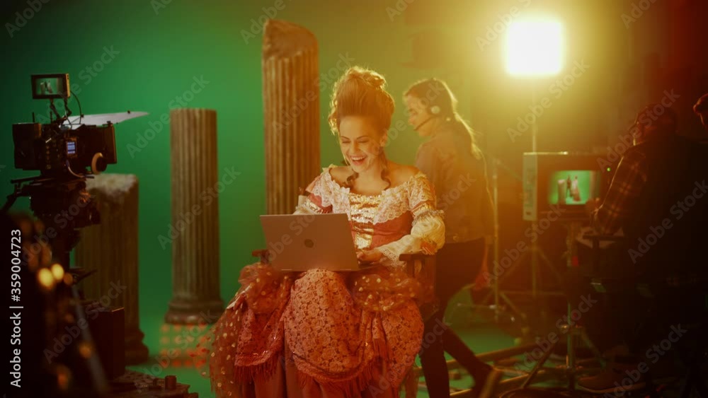 Actress Using Computer On Period Costume Drama Film Set: Beautiful Smiling Actress Wearing ...