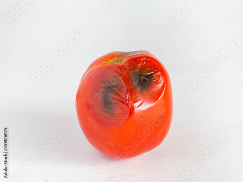 Rotten Tomatoes,Is a red fruit
Sour and sweet,Skin has black mold,
White background