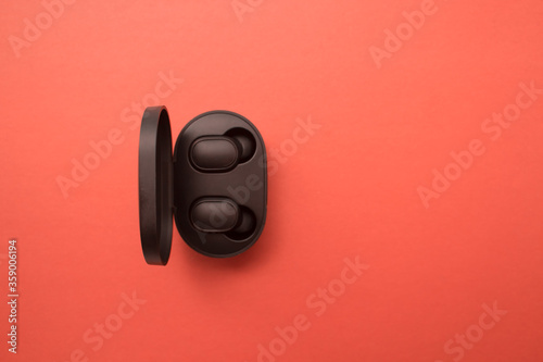 Wireless earphones for the phone, a modern accessory for active people. Card with copy space for text