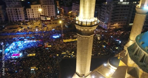 Beirut, Lebanon 2019 : night drone of Martyr square, with mosque minarets in foreground while thousands of protesters are revolting against government failure during the Lebanese revolution photo