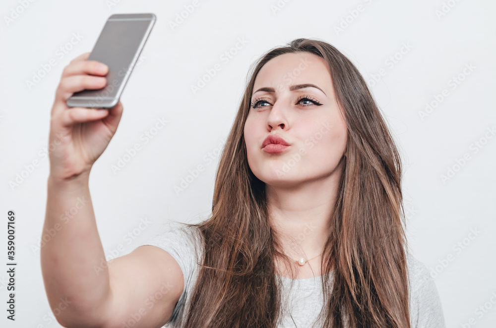 Pretty girl taking selfie on cell phone camera. Pretty girl taking selfie on cell phone camera.