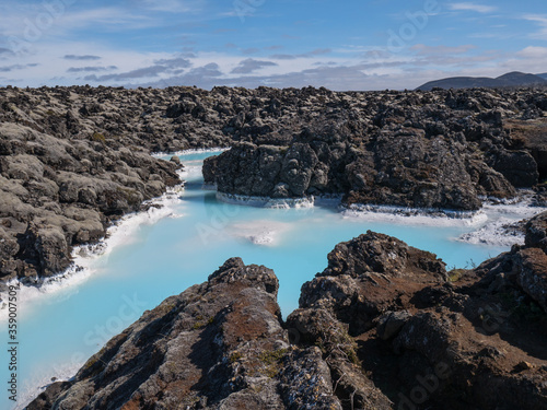 Blue lagoon water in lava field landscape, natural geothermal spa area near Reykjavik, Iceland © Alena